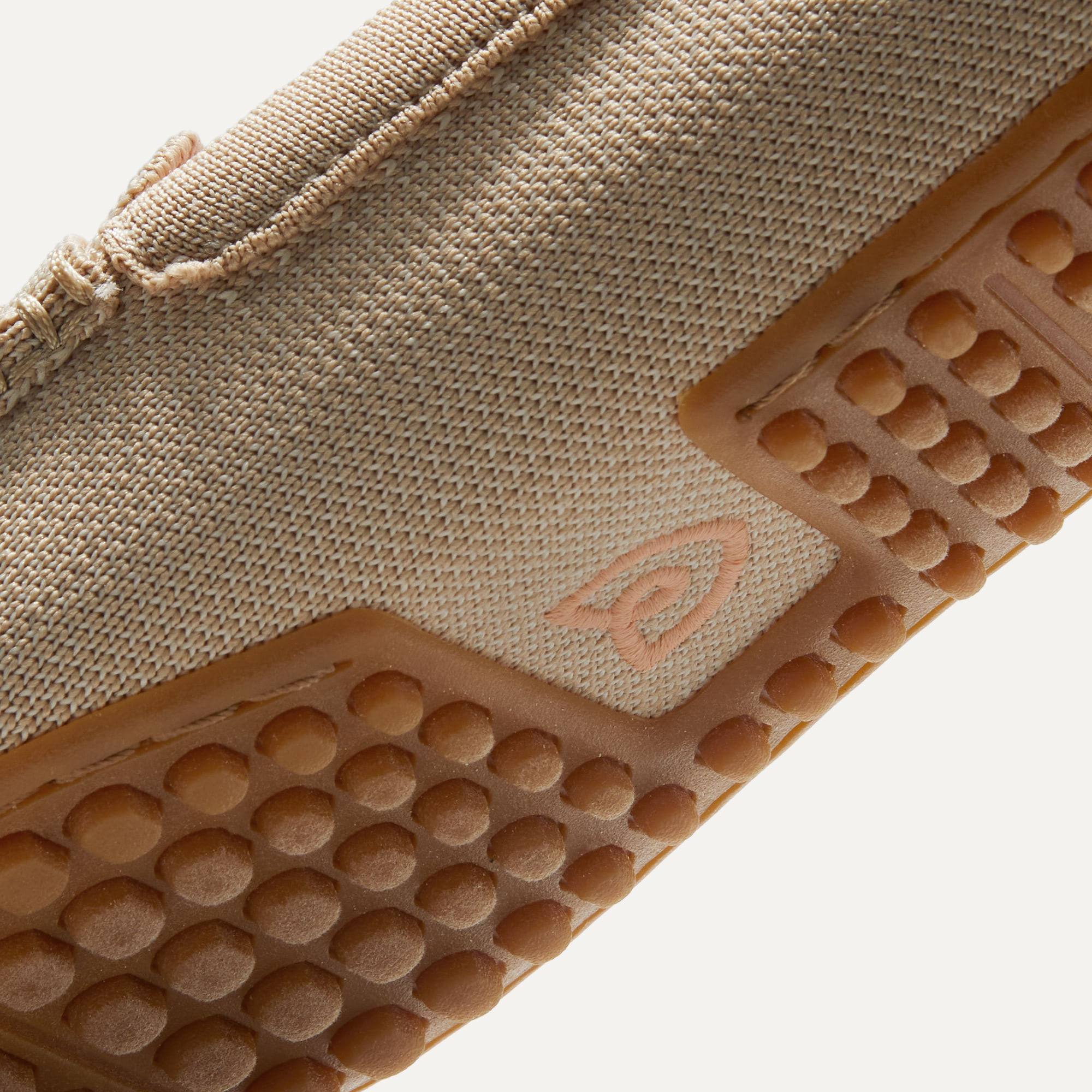 Close up of the raised nub outsoles of The Driver in Sesame.