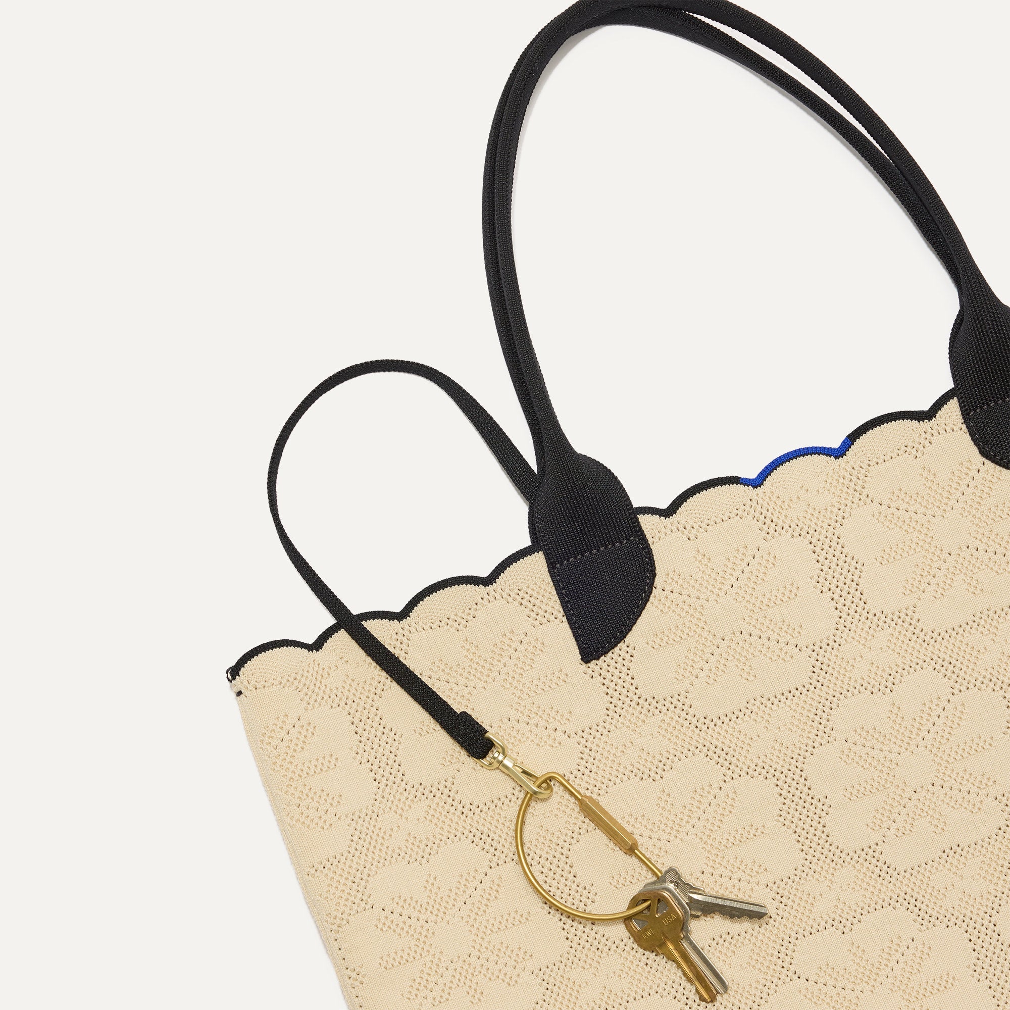 The Lightweight Tote in Ivory Carnation shown with its handy key leash.