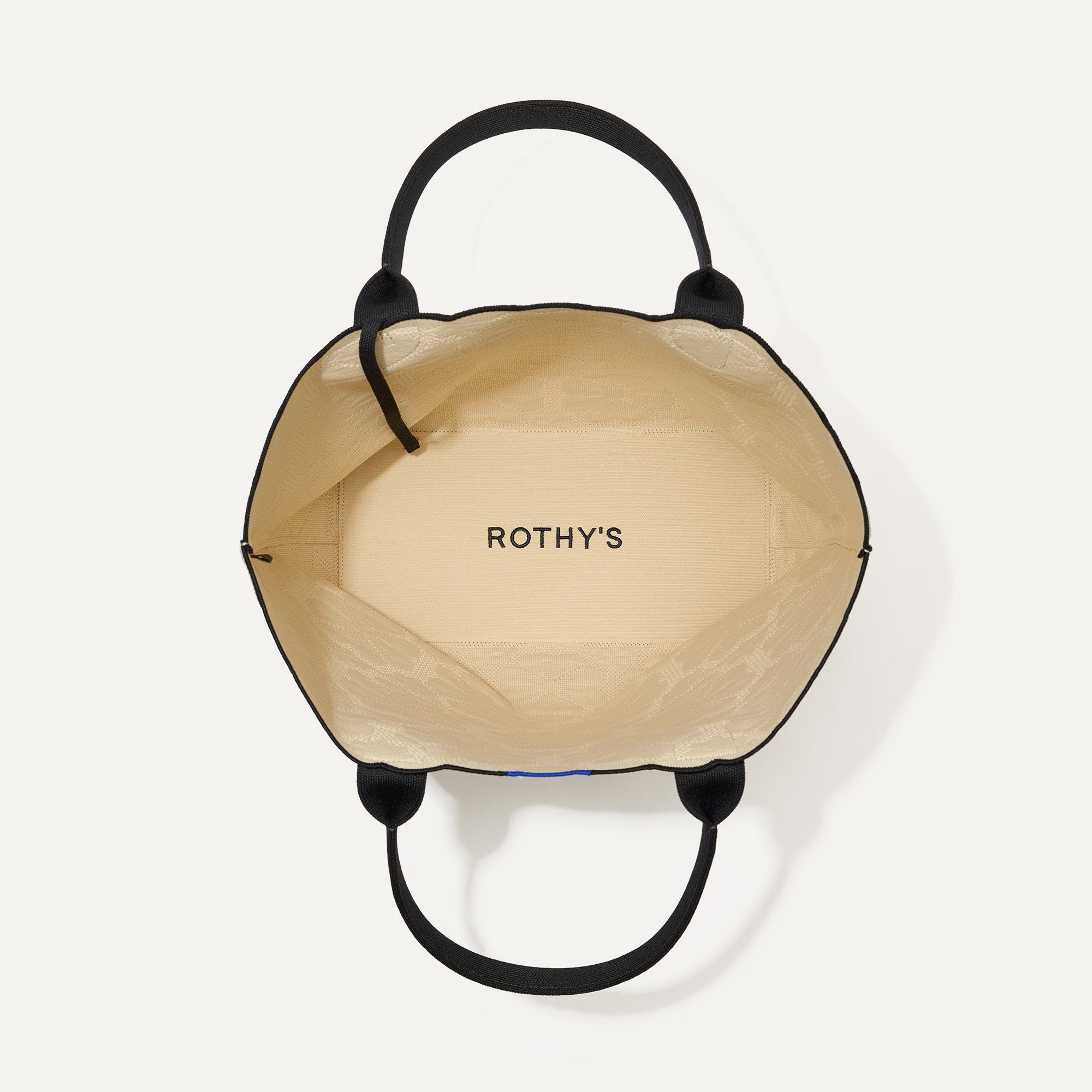 The Lightweight Tote in Ivory Carnation shown open from the top, with interior visible. 