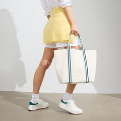 hover | Model holding The Lightweight Tote in Birdie.