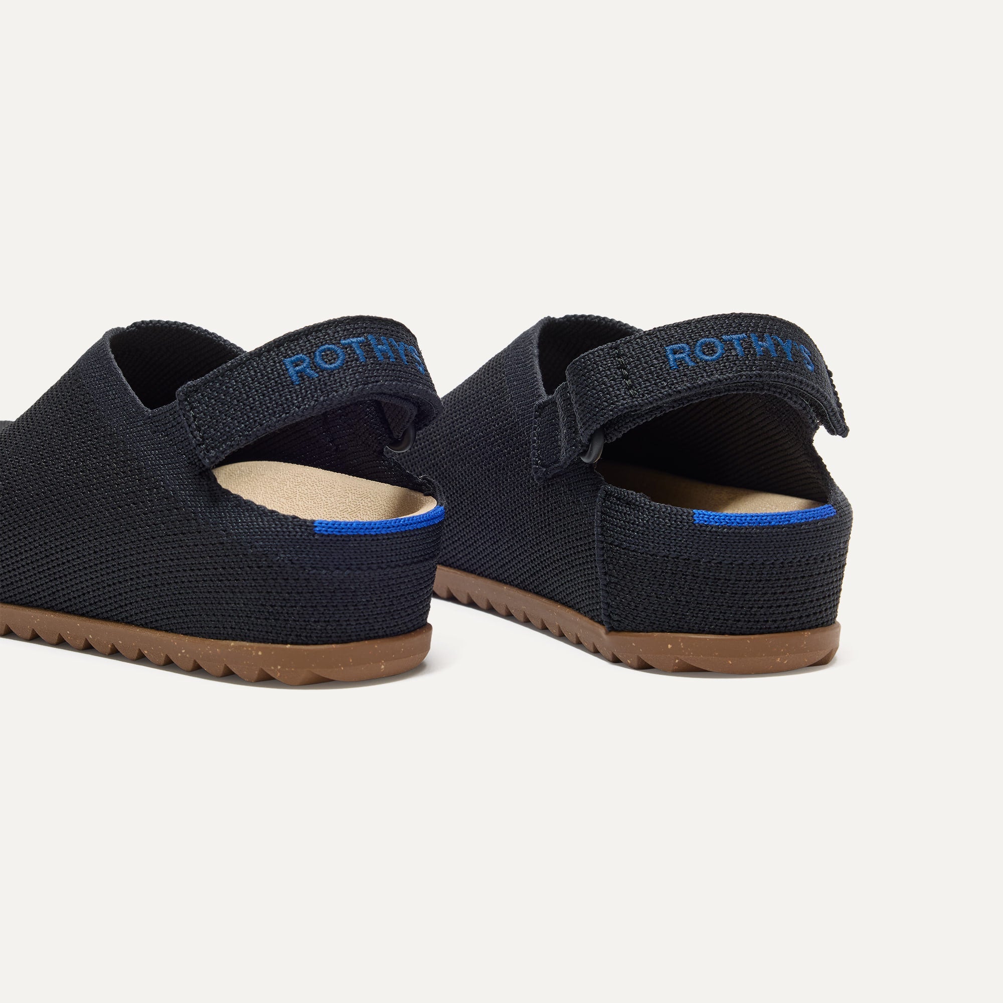 Close up of the heel of The Kids Clog in Black, with Rothy's signature blue halo. 